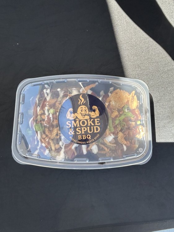 Loaded potato packaged with a Smoke & Spud BBQ sticker