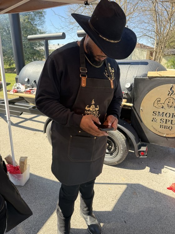 Smoke & Spud team member beside the smoker