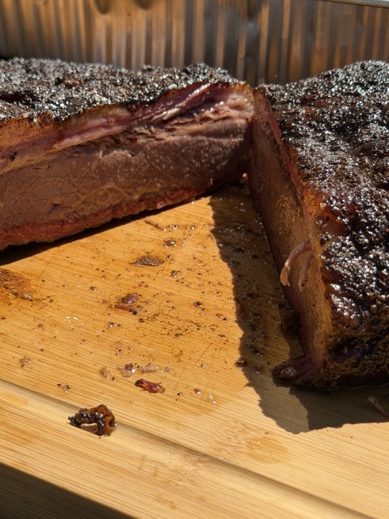 Smoked brisket sliced on a wooden cutting board